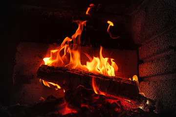 Burning wood in brick fireplace