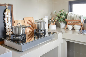 Fototapeta na wymiar stainless pan on gas stove with utensil in modern kitchen