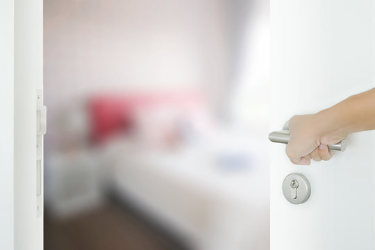 man hand opening white door to bedroom in modern intrior style