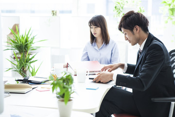 Men and women are working in the office