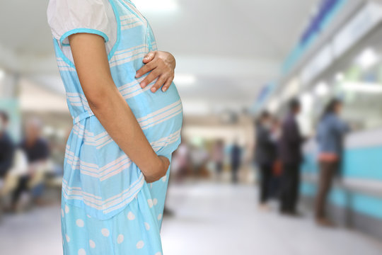 Pregnant women wear blue maternity clothes.