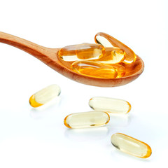 Spoonful of gel capsules of omega 3. Close up capsules fish oil