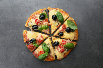 Sliced delicious pizza on gray background