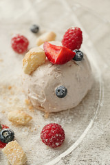 Ice cream with berries and mint leaves on plate