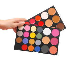 Female hand holding eye shadow palette, isolated on white