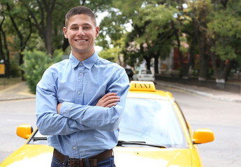 Male taxi driver near car