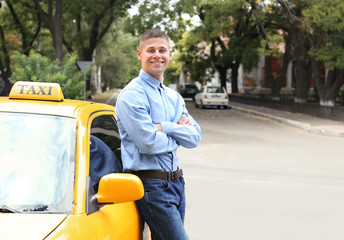 Male taxi driver near car