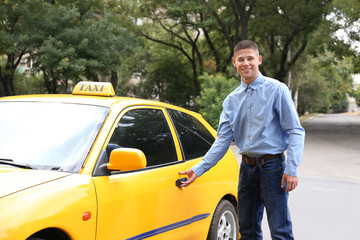 Male taxi driver near car