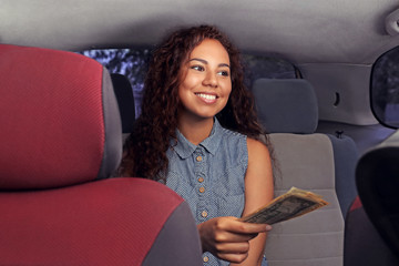 Beautiful girl paying for taxi