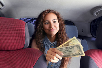 Beautiful girl paying for taxi