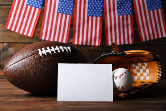 American flags with sport items on wooden background - Powered by Adobe