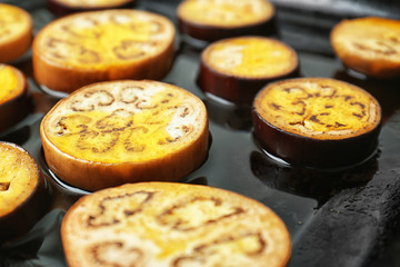 Sliced eggplant on baking tray, closeup