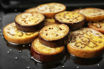Sliced eggplant on baking tray, closeup