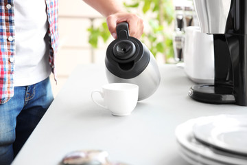 Man making morning coffee in kitchen