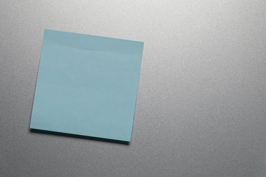Empty blue paper sheet on refrigerator door.