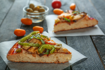 Tasty homemade pizza slices on table