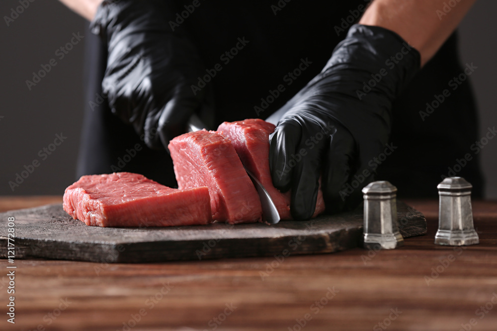 Canvas Prints butcher cutting pork meat on kitchen