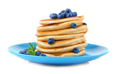 Tasty pancakes with blueberries on plate, isolated on white