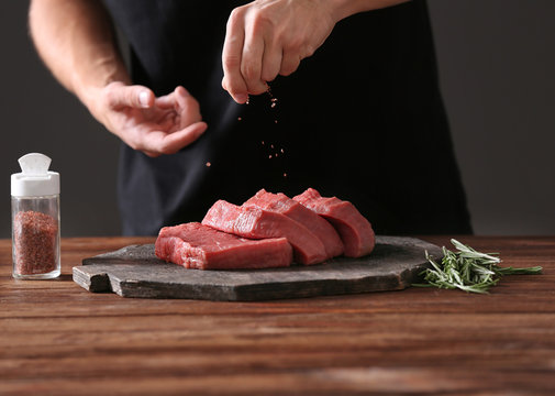 Butcher cooking pork meat on kitchen