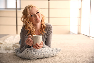Beautiful girl drinking coffee at home