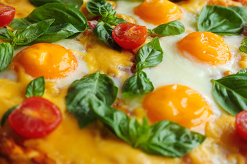 Margarita pizza with basil leaves and egg closeup