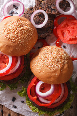 sandwiches: black bean burgers and fresh vegetables close-up. Vertical top view
