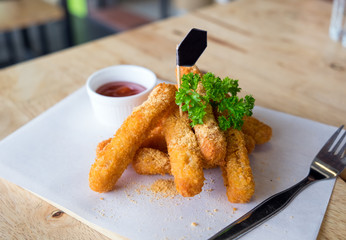 Chicken cheese stick with tomato sauce on white dish