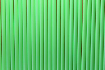 Drink tube of green color in abstract background.