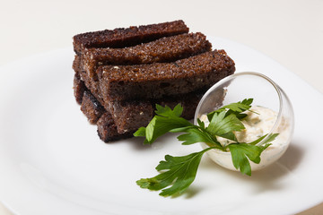 Toasts from black bread and sauce