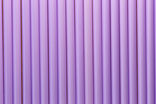 Drink tube of violet color in abstract background.