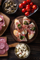 Spanish tapas with slices jamon serrano, salami, olives and chee