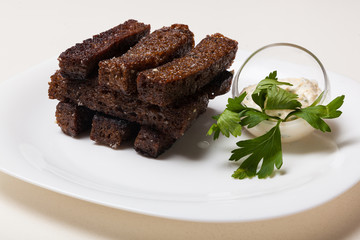 Toasts from black bread and sauce
