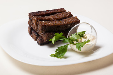 Toasts from black bread and sauce
