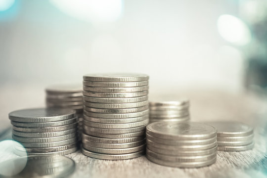 rows of coins and blurred bokeh background for finance and banking concept

