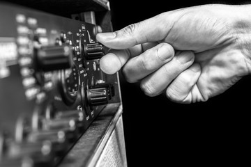 right hand tuning knobs of studio gears, pre-amp, audio interface, effect signal processor isolated on black for TV radio broadcasting, post production or music concept