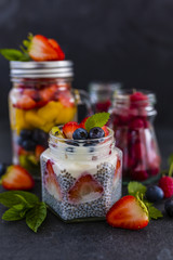 Fototapeta na wymiar Chia seeds with yogurt and fresh berries fruit on stone background. 