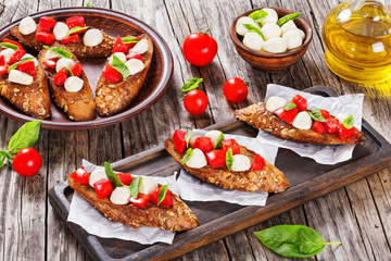 bruschetta with tomatoes, mozzarella and basil, close-up