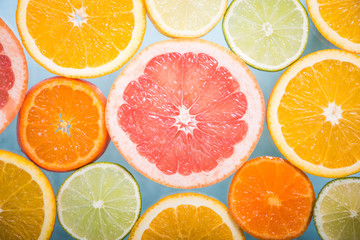 Mixed citrus slices overhead view background