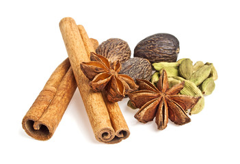 Anise, cardamom, nutmeg and cinnamon sticks on a white backgroun