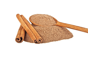 Cinnamon sticks and powder in wooden spoon on a white background