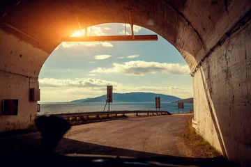 Photo sur Plexiglas Tunnel The end of the tunnel. Driving a car on a mountain road