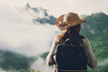 Woman traveler looking fog on the mountain