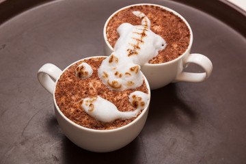 Coffee with foam in the form of cat and mouse