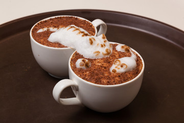 Coffee with foam in the form of cat and mouse