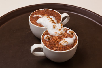 Coffee with foam in the form of cat and mouse