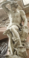 Obraz premium male figure sculpture on the facade of an old house in Art Nouveau style 