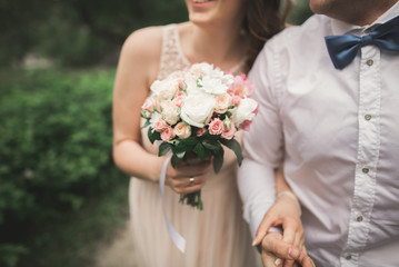 beautiful wedding couple in park. kiss and hug each other