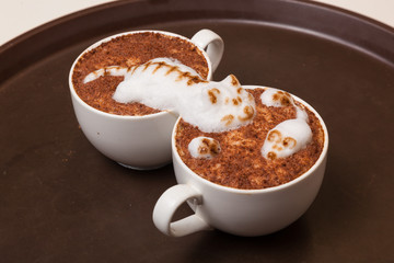 Coffee with foam in the form of cat and mouse