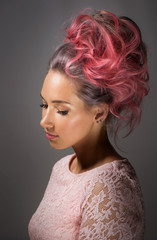 Portrait of a beautiful girl with dyed hair, professional hair colouring on grey background