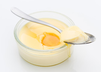 Spoon takes a piece of homemade custard, isolated